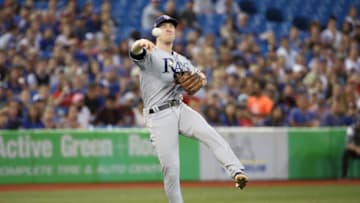 TORONTO, ON - AUGUST 10: Joey Wendle #18 of the Tampa Bay Rays hurries the throw to first base but cannot get the baserunner in time as Luke Maile #21 of the Toronto Blue Jays hits a soft infield single in the sixth inning during MLB game action at Rogers Centre on August 10, 2018 in Toronto, Canada. (Photo by Tom Szczerbowski/Getty Images)