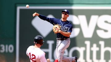 BOSTON, MA - AUGUST 19: Brandon Lowe #35 of the Tampa Bay Rays turns a double play over the slide of Brock Holt #12 of the Boston Red Sox in the fifth inning of a game at Fenway Park on August 19, 2018 in Boston, Massachusetts. (Photo by Adam Glanzman/Getty Images)