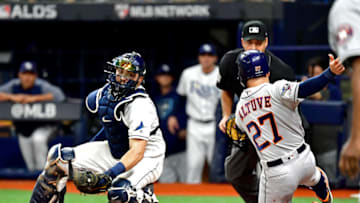 ST PETERSBURG, FLORIDA - OCTOBER 08: Jose Altuve #27 of the Houston Astros is tagged out at home plate by Travis d'Arnaud #37 of the Tampa Bay Rays while attempting to score a run during the fourth inning in game four of the American League Division Series at Tropicana Field on October 08, 2019 in St Petersburg, Florida. (Photo by Julio Aguilar/Getty Images)