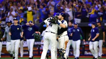 ST PETERSBURG, FLORIDA - OCTOBER 08: Blake Snell #4 and Travis d'Arnaud #37 of the Tampa Bay Rays celebrate their teams 4-1 win over the Houston Astros in game four of the American League Division Series at Tropicana Field on October 08, 2019 in St Petersburg, Florida. (Photo by Julio Aguilar/Getty Images)