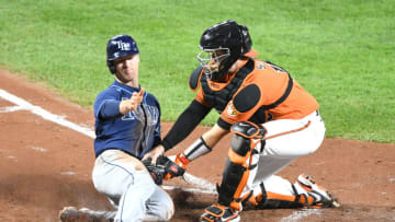 BALTIMORE, MD - SEPTEMBER 19: Chance Sisco #15 of the Baltimore Orioles tags out Joey Wendle #18 of the Tampa Bay Rays at home on a Kevin Kiermaier #39 (not pictured) fields choice in the forth inning pitches during a baseball game against the Tampa Bay Rays at Oriole Park at Camden Yards on September 19, 2020 in Baltimore, Maryland. (Photo by Mitchell Layton/Getty Images)