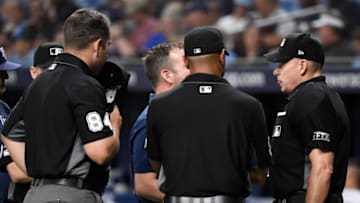 ST PETERSBURG, FLORIDA - JULY 27: MLB umpire Andy Fletcher #49 is looked at by medical staff after being hit by a baseball during the eighth inning of the game between the Tampa Bay Rays and the New York Yankees at Tropicana Field on July 27, 2021 in St Petersburg, Florida. (Photo by Douglas P. DeFelice/Getty Images)