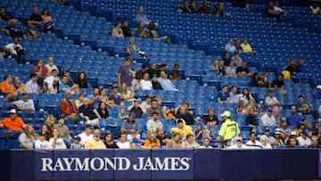 ST. PETERSBURG, FL - SEPTEMBER 17: Baseball fans sit among empty seats during the fifth inning of a game between the Baltimore Orioles and the Tampa Bay Rays on September 17, 2015 at Tropicana Field in St. Petersburg, Florida. (Photo by Brian Blanco/Getty Images)