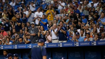 ST. PETERSBURG, FL - APRIL 29: Fans seated near the Tampa Bay Rays' dugout cheer as manger Kevin Cash #16 of the Tampa Bay Rays makes his way off of the field after being ejected by home plate umpire Mark Ripperger #90 during the fifth inning of a game against the Toronto Blue Jays on April 29, 2016 at Tropicana Field in St. Petersburg, Florida. (Photo by Brian Blanco/Getty Images)