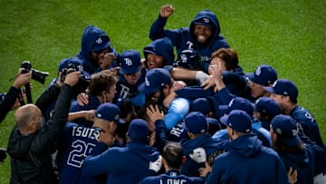 The Tampa Bay Rays celebrate right fielder Brett Phillips (14) hitting the game winning walk off single against the Los Angeles Dodgers during the ninth inning in game four of the 2020 World Series at Globe Life Field. Mandatory Credit: Jerome Miron-USA TODAY Sports