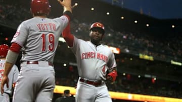 Sep 15, 2015; San Francisco, CA, USA; Cincinnati Reds first baseman Joey Votto (19) greets second baseman Brandon Phillips (4) after he scored on a two run triple RBI by shortstop Ivan De Jesus Jr. (not pictured) in the first inning against the San Francisco Giants at AT&T Park. Mandatory Credit: Lance Iversen-USA TODAY Sports