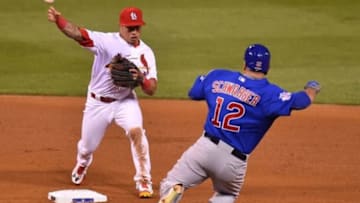 Oct 9, 2015; St. Louis, MO, USA; St. Louis Cardinals second baseman Kolten Wong (16) attempts a double play as Chicago Cubs outfielder Kyle Schwarber (12) slides into the bag in game one of the NLDS at Busch Stadium. Mandatory Credit: Jasen Vinlove-USA TODAY Sports