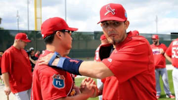 Feb 18, 2016; Jupiter, FL, USA; St. Louis Cardinals catcher Yadier Molina (right) greets relief pitcher Seung Hwan Oh (left) at Roger Dean Stadium. Mandatory Credit: Steve Mitchell-USA TODAY Sports