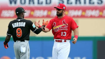 Mar 3, 2016; Jupiter, FL, USA; Miami Marlins second baseman Dee Gordon (left) greets St. Louis Cardinals third baseman Matt Carpenter (right) before their spring training game at Roger Dean Stadium. Mandatory Credit: Steve Mitchell-USA TODAY Sports