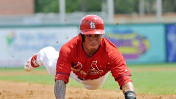Mar 23, 2014; Jupiter, FL, USA; St. Louis Cardinals second baseman Kolten Wong (16) dives into third base on a steal during a game against the Houston Astros at Roger Dean Stadium. Mandatory Credit: Steve Mitchell-USA TODAY Sports