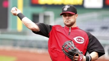 Apr 22, 2014; Pittsburgh, PA, USA; Cincinnati Reds infielder Skip Schumaker (25) throws on the field before playing the Pittsburgh Pirates at PNC Park. Mandatory Credit: Charles LeClaire-USA TODAY Sports