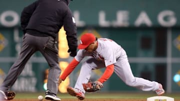 Apr 5, 2016; Pittsburgh, PA, USA; St. Louis Cardinals second baseman Kolten Wong (16) reaches for an errant throw as second base umpire Clint Fagen (L) looks on against the Pittsburgh Pirates during the eleventh inning at PNC Park. The Pirates won 6-5 in eleven innings. Mandatory Credit: Charles LeClaire-USA TODAY Sports