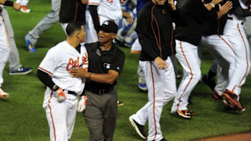 Jun 7, 2016; Baltimore, MD, USA; Baltimore Orioles shortstop Manny Machado (13) is restrained by first base umpire C.B. Bucknor (center) during a brawl in the fifth inning against the Kansas City Royals at Oriole Park at Camden Yards. The Orioles won 9-1. Mandatory Credit: Evan Habeeb-USA TODAY Sports
