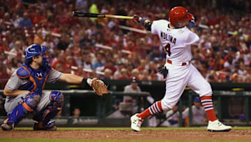Aug 23, 2016; St. Louis, MO, USA; St. Louis Cardinals catcher Yadier Molina (4) hits a single off of New York Mets starting pitcher Robert Gsellman (not pictured) during the third inning at Busch Stadium. The Mets won 7-4. Mandatory Credit: Jeff Curry-USA TODAY Sports
