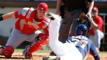 Mar 4, 2016; Kissimmee, FL, USA; Houston Astros Andrew Aplin (77) is safe at home as St. Louis Cardinals catcher Carson Kelly (82) drops the ball while trying to tag him during the fourth inning at Osceola County Stadium. Mandatory Credit: Butch Dill-USA TODAY Sports