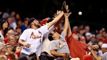 Sep 19, 2016; Denver, CO, USA; Fans reach for a ball tossed into the stands in the first inning of the game between the Colorado Rockies and the St. Louis Cardinals at Coors Field. Mandatory Credit: Isaiah J. Downing-USA TODAY Sports