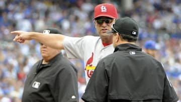 Sep 23, 2016; Chicago, IL, USA; St. Louis Cardinals manager Mike Matheny (22) argues a call with umpire Jim Reynolds (77) during the third inning against the Chicago Cubs at Wrigley Field. Mandatory Credit: David Banks-USA TODAY Sports