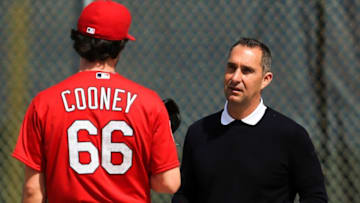 Feb 18, 2016; Jupiter, FL, USA; St. Louis Cardinals general manager John Mozeliak (right) talks with St. Louis Cardinals starting pitcher Tim Cooney (left) prior to warm ups at Roger Dean Stadium. Mandatory Credit: Steve Mitchell-USA TODAY Sports