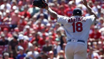 4, 2016; Cincinnati, OH, USA; St. Louis Cardinals starting pitcher Carlos Martinez dodges a broken bat during the fifth inning against the Cincinnati Reds at Great American Ball Park. Mandatory Credit: David Kohl-USA TODAY Sports