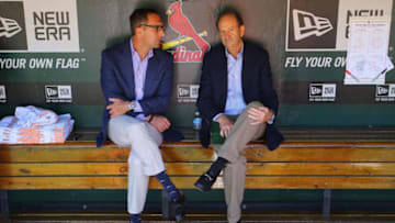 John Mozeliak (L) and Bill DeWitt, Jr. managing partner and chairman of the St. Louis Cardinals talk in the dugout prior to a game against the Chicago Cubs at Busch Stadium on September 29, 2013 in St. Louis, Missouri. The Cardinals beat the Cubs 4-0. (Photo by Dilip Vishwanat/Getty Images)