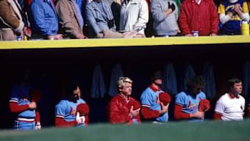 MILWAUKEE, WI - OCTOBER 15: Dane Iorg, Joaquin Andujar, manager Whitey Herzog, Bob Forch, Mike Ramsey, and trainer Gene Gieselmann of the St. Louis Cardinals stand for the national anthem before Game 3 of the World Series on October 15, 1982 at Milwaukee County Stadium in Milwaukee, Wisconsin. (Photo by St. Louis Cardinals, LLC/Getty Images)