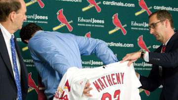 ST. LOUIS, MO - NOVEMBER 14: St. Louis Cardinals general manager John Mozeliak (R) and owner Bill Dewitt Jr. (L) introduce Mike Matheny (C) as the new manager during a press conference at Busch Stadium on November 14, 2011 in St. Louis, Missouri. (Photo by Jeff Curry/Getty Images)