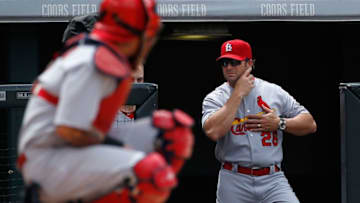 DENVER, CO - JUNE 10: Manager Mike Matheny #26 of the St. Louis Cardinals sends signals from the dugout to catcher Yadier Molina #4 of the St. Louis Cardinals as they face the Colorado Rockies at Coors Field on June 10, 2015 in Denver, Colorado. (Photo by Doug Pensinger/Getty Images)