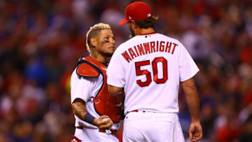 Yadier Molina #4 and starter Adam Wainwright #50 of the St. Louis Cardinals talk in between pitches against the Chicago Cubs in the fifth inning at Busch Stadium on April 4, 2017 in St. Louis, Missouri. (Photo by Dilip Vishwanat/Getty Images)