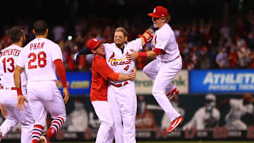 ST. LOUIS, MO - MAY 1: Yadier Molina #4 of the St. Louis Cardinals is mobbed by Jedd Gyorko #3 and Harrison Bader #48 of the St. Louis Cardinals after hitting a walk-off single against the Chicago White Sox in the ninth inning at Busch Stadium on May 1, 2018 in St. Louis, Missouri. (Photo by Dilip Vishwanat/Getty Images)