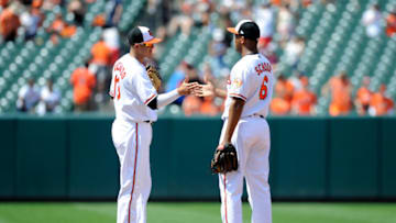 BALTIMORE, MD - JULY 01: Manny Machado #13 and Jonathan Schoop #6 of the Baltimore Orioles celebrate after a 8-2 victory against the Los Angeles Angels at Oriole Park at Camden Yards on July 1, 2018 in Baltimore, Maryland. (Photo by Greg Fiume/Getty Images)