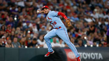 Nolan Arenado (28) attempts a throw to first base in the fourth inning against the Colorado Rockies at Coors Field. Mandatory Credit: Isaiah J. Downing-USA TODAY Sports