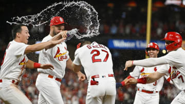 Tyler O'Neill (27) is congratulated by second baseman Tommy Edman (19) and designated hitter Albert Pujols (5) after a walk-off hit by pitch with the bases loaded against the Colorado Rockies during the ninth inning at Busch Stadium. Mandatory Credit: Jeff Curry-USA TODAY Sports