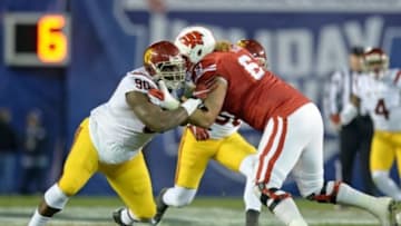 Dec 30, 2015; San Diego, CA, USA; USC Trojans defensive end Claude Pelon (90) works against Wisconsin Badgers offensive lineman Tyler Marz (61) during the second quarter in the 2015 Holiday Bowl at Qualcomm Stadium. Mandatory Credit: Jake Roth-USA TODAY Sports