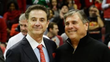 Nov 26, 2014; Louisville, KY, USA; Louisville Cardinals head coach Rick Pitino celebrates his 700th win with Athletic Director Tom Jurich following the second half agains the Cleveland State Vikings at KFC Yum! Center. Louisville defeated Cleveland State 45-33. Mandatory Credit: Jamie Rhodes-USA TODAY Sports