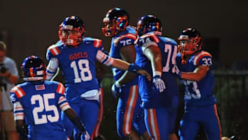Sep 26, 2014; Las Vegas, NV, USA; Bishop Gorman Gaels quarterback Tate Martell (18) celebrates with teammates after scoring a rushing touchdown against St John Bosco during the first quarter of a game at Fertitta Field. Bishop Gorman won the game 34-31. Mandatory Credit: Stephen R. Sylvanie-USA TODAY Sports