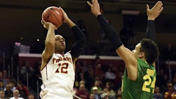 Mar 5, 2016; Los Angeles, CA, USA; Southern California Trojans guard Julian Jacobs (12) shoots over Oregon Ducks forward Dillon Brooks (24) during the game at Galen Center. Mandatory Credit: Richard Mackson-USA TODAY Sports