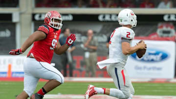 Sep 6, 2014; Salt Lake City, UT, USA; Fresno State Bulldogs quarterback Brian Burrell (2) rolls out while pursued by Utah Utes defensive tackle Stevie Tu