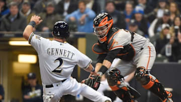 Apr 4, 2016; Milwaukee, WI, USA; San Francisco Giants catcher Buster Posey (28) tags out Milwaukee Brewers second baseman Scooter Gennett (2) trying to score on a hit by right fielder Domingo Santana (not pictured) in the fourth inning at Miller Park. Mandatory Credit: Benny Sieu-USA TODAY Sports