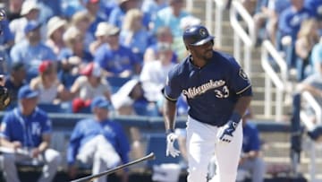 Mar 24, 2016; Phoenix, AZ, USA; Milwaukee Brewers first baseman Chris Carter (33) hits a three run home run against the Kansas City Royals in the fifth inning during a spring training game at Maryvale Baseball Park. Mandatory Credit: Rick Scuteri-USA TODAY Sports