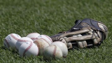 Jul 4, 2014; Pittsburgh, PA, USA; MLB baseballs and a glove sit on the field prior to the Pittsburgh Pirates against the Philadelphia Phillies at PNC Park. Mandatory Credit: Charles LeClaire-USA TODAY Sports