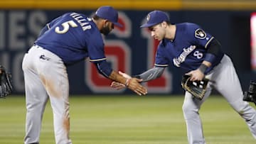 May 24, 2016; Atlanta, GA, USA; Milwaukee Brewers shortstop Jonathan Villar (5) and left fielder Ryan Braun (8) celebrate a victory against the Atlanta Braves at Turner Field. The Brewers defeated the Braves 2-1. Mandatory Credit: Brett Davis-USA TODAY Sports