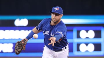 TORONTO, ON - MARCH 30: Justin Smoak #14 of the Toronto Blue Jays flips the ball to the pitcher covering first base after fielding a grounder to get the baserunner at first base in the fourth inning during MLB game action against the Detroit Tigers at Rogers Centre on March 30, 2019 in Toronto, Canada. (Photo by Tom Szczerbowski/Getty Images)
