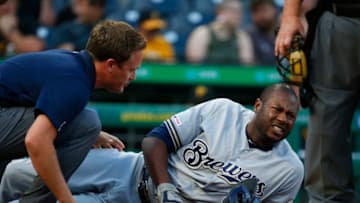 PITTSBURGH, PA - AUGUST 06: Head athletic trainer Scott Barringer tends to injured Lorenzo Cain #6 of the Milwaukee Brewers in the first inning against the Pittsburgh Pirates at PNC Park on August 6, 2019 in Pittsburgh, Pennsylvania. (Photo by Justin K. Aller/Getty Images)