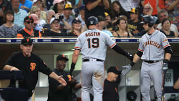 SAN DIEGO, CALIFORNIA - JULY 26: Tyler Austin #19 o is congratulated at the dugout by manager Bruce Bochy of the San Francisco Giants after scoring on an RBI double hit by Donovan Solano #7 of the San Francisco Giants during the third inning of a game against the San Diego Padresat PETCO Park on July 26, 2019 in San Diego, California. (Photo by Sean M. Haffey/Getty Images)