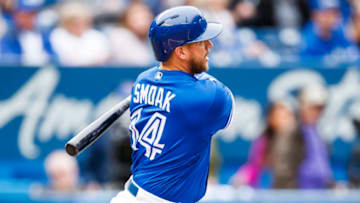 TORONTO, ONTARIO - SEPTEMBER 29: Justin Smoak #14 of the Toronto Blue Jays hits a two-run double against the Tampa Bay Rays in the first inning at the Rogers Centre on September 29, 2019 in Toronto, Canada. (Photo by Mark Blinch/Getty Images)