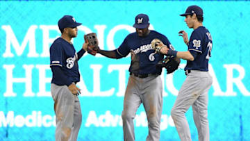MIAMI, FLORIDA - SEPTEMBER 09: Trent Grisham #2, Lorenzo Cain #6, and Christian Yelich #22 of the Milwaukee Brewers celebrate the win against the Miami Marlins at Marlins Park on September 09, 2019 in Miami, Florida. (Photo by Mark Brown/Getty Images)