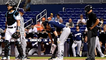 MIAMI, FLORIDA - SEPTEMBER 10: Christian Yelich #22 of the Milwaukee Brewers is checked out by the medical staff after an injury from ball deflection in the first inning against the Miami Marlins at Marlins Park on September 10, 2019 in Miami, Florida. (Photo by Mark Brown/Getty Images)