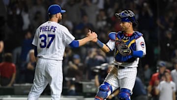 CHICAGO, ILLINOIS - SEPTEMBER 16: David Phelps #37 and Willson Contreras #40 of the Chicago Cubs shake hands after defeating the Cincinnati Reds at Wrigley Field on September 16, 2019 in Chicago, Illinois. (Photo by Quinn Harris/Getty Images)