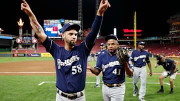 CINCINNATI, OH - SEPTEMBER 25: Alex Claudio #58 and Junior Guerra #41 of the Milwaukee Brewers celebrate after clinching a playoff berth following a 9-2 win over the Cincinnati Reds at Great American Ball Park on September 25, 2019 in Cincinnati, Ohio. (Photo by Joe Robbins/Getty Images)