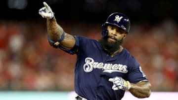 WASHINGTON, DC - OCTOBER 01: Eric Thames #7 of the Milwaukee Brewers celebrates after scoring a home run against Max Scherzer #31 of the Washington Nationals during the second inning in the National League Wild Card game at Nationals Park on October 01, 2019 in Washington, DC. (Photo by Rob Carr/Getty Images)